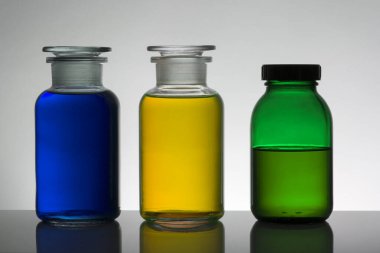 Laboratuvar şişelerinde sıvı. Bilimsel biyokimya laboratuvarı. Renkli sıvı.