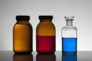 Laboratuvar şişelerinde sıvı. Bilimsel biyokimya laboratuvarı. Renkli sıvı.