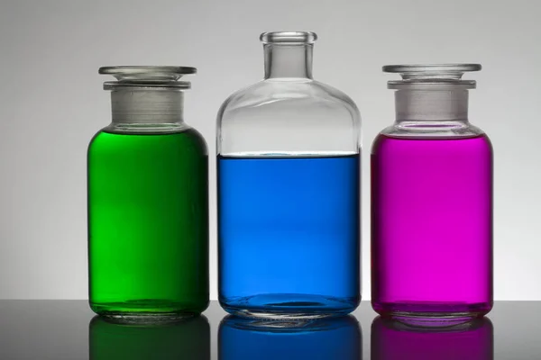 Liquido in bottiglie da laboratorio. Laboratorio biochimico scientifico. Liquido colorato . — Foto Stock