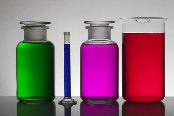 Liquid in laboratory bottles. Scientific biochemical laboratory. Colorful liquid. — ストック写真