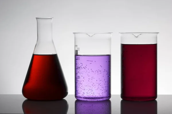 Liquid in laboratory bottles. Scientific biochemical laboratory. Colorful liquid. — Stock Photo, Image