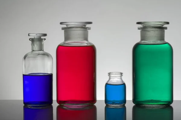 Liquid in laboratory bottles. Scientific biochemical laboratory. Colorful liquid. — ストック写真