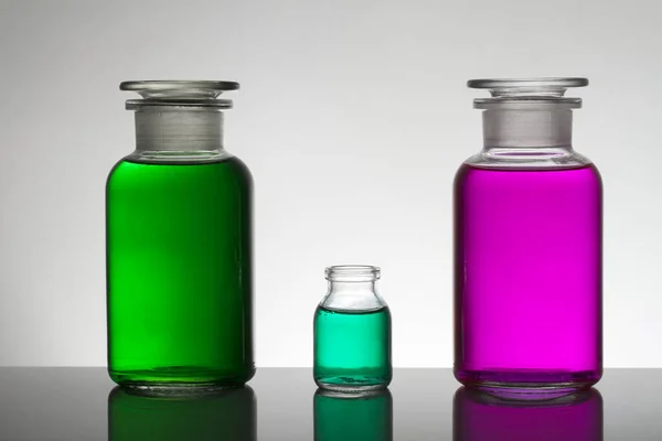 Liquide dans des bouteilles de laboratoire. Laboratoire biochimique scientifique. Liquide coloré . — Photo