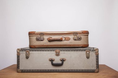 Old, retro, suitcases lie on the table with white background clipart