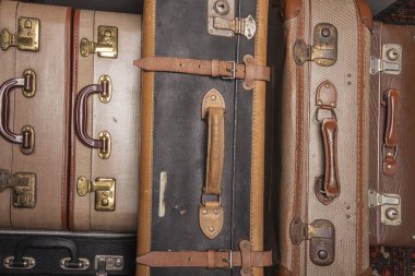 Eski, eski, beyaz arka planlı bavullar masanın üzerinde.