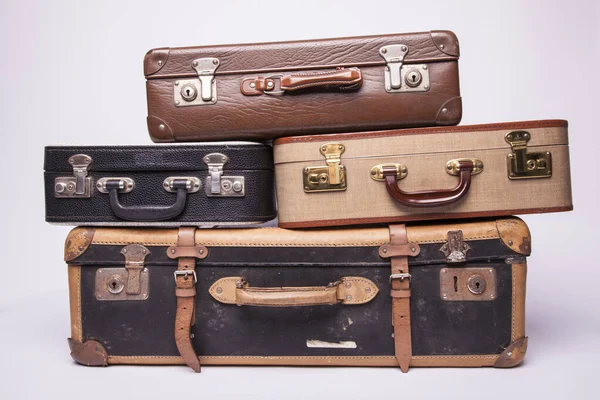 Old, retro, suitcases lie on the table with white background — Stock Photo, Image