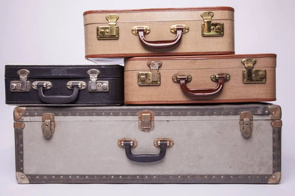 Old, retro, suitcases lie on the table with white background — Stock Photo, Image