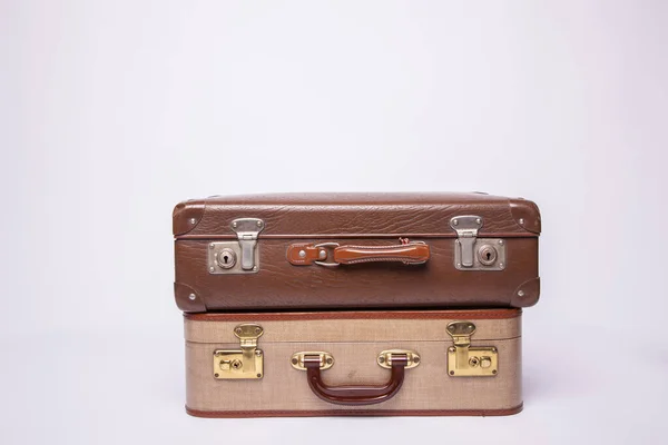 Old, retro, suitcases lie on the table with white background — Stock Photo, Image