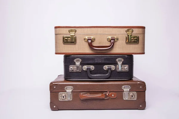 Old, retro, suitcases lie on the table with white background — Stock Photo, Image