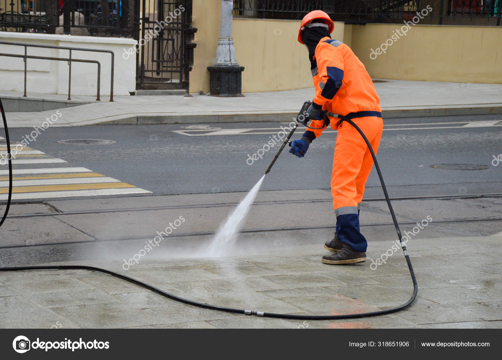Worker Hose Washes Sidewalk Stock Photo by ©alkhanz 318651906