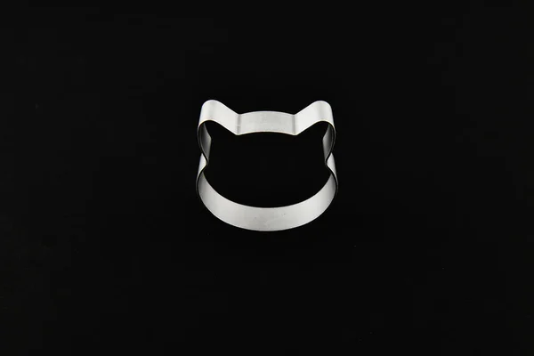 cat logo on a black background. Cat head logo. Abstract logo with a cat's head in black and white. Metolic cat.