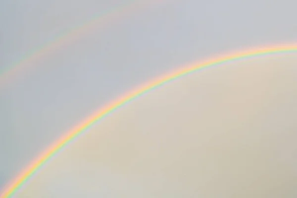 double rainbow in the sky. after the rain. natural miracle. cloudy sky on a rainbow background. a symbol of peace. and lgbt