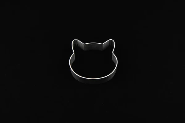 cat logo on a black background. Cat head logo. Abstract logo with a cat\'s head in black and white. Metolic cat.