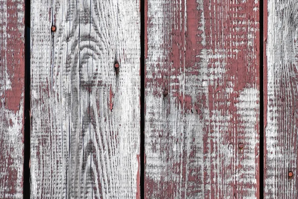 Red-gray wooden background. vertical boards. old paint peels off. old boards. Red gray wood texture of a worn painted board. Red gray wood texture of old worn painted board — Stock Photo, Image