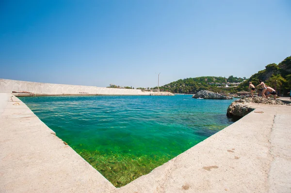 Concrete pier, vacationers dive into the pier