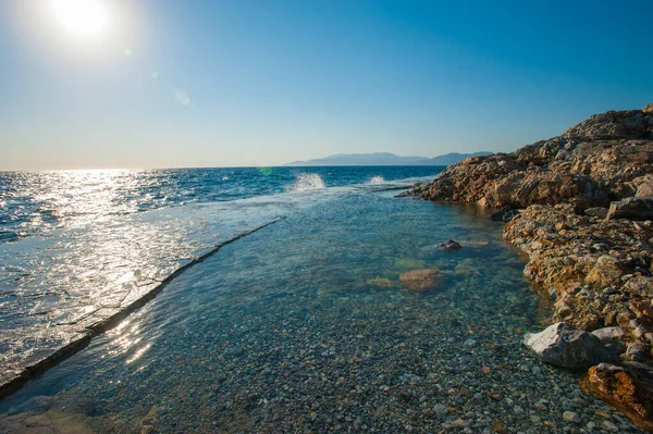 Waves hit the hard surface of concrete slabs