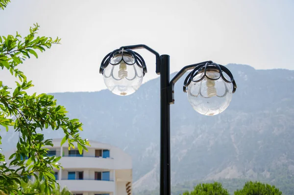 Energy-saving light bulbs in the lantern on the nature near the mountains — Stock Photo, Image