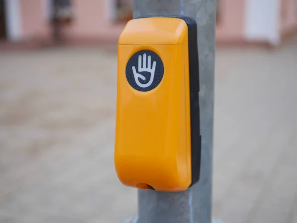 Drücken, um die Straße zu überqueren. Gelber Knopf zum sicheren Überqueren der Straße an einer Eisenstange — Stockfoto