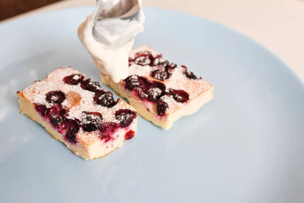 cottage cheese casserole with berries on a plate. Homemade cottage cheese casserole with berries on a plate. Delicious homemade cottage cheese casserole with berries on a plate