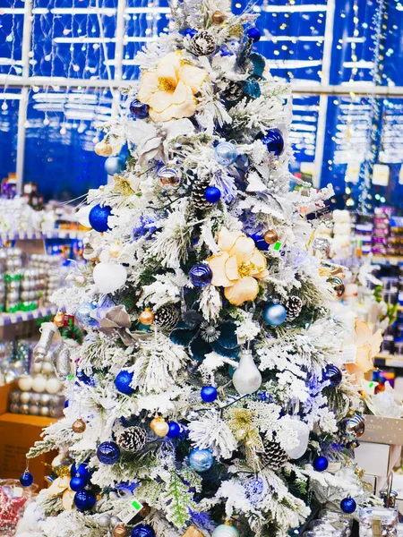 White decorated Christmas tree. White decorated Christmas trees with many gifts in delicate pastel colors. Good New Year spirit. White decorated Christmas tree with many gifts.