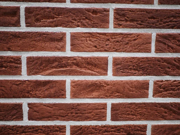 Pomarańczowa ceglana fasada. Rozdarta struktura kamienia. Kamienny mur. abstrakcyjne tło — Zdjęcie stockowe