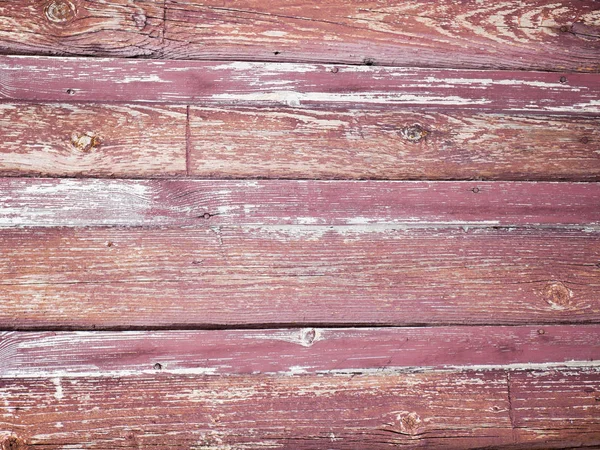 Old red wall made of wood. An old painted surface made of wood for design and creativity. Texture of an old red painted board made of wood for creativity and backgrounds — Stock Photo, Image