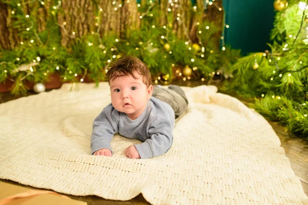 Uma criança perto da árvore de Natal. Rapazinho a celebrar o Natal. primeiro Natal do bebê . — Fotografia de Stock