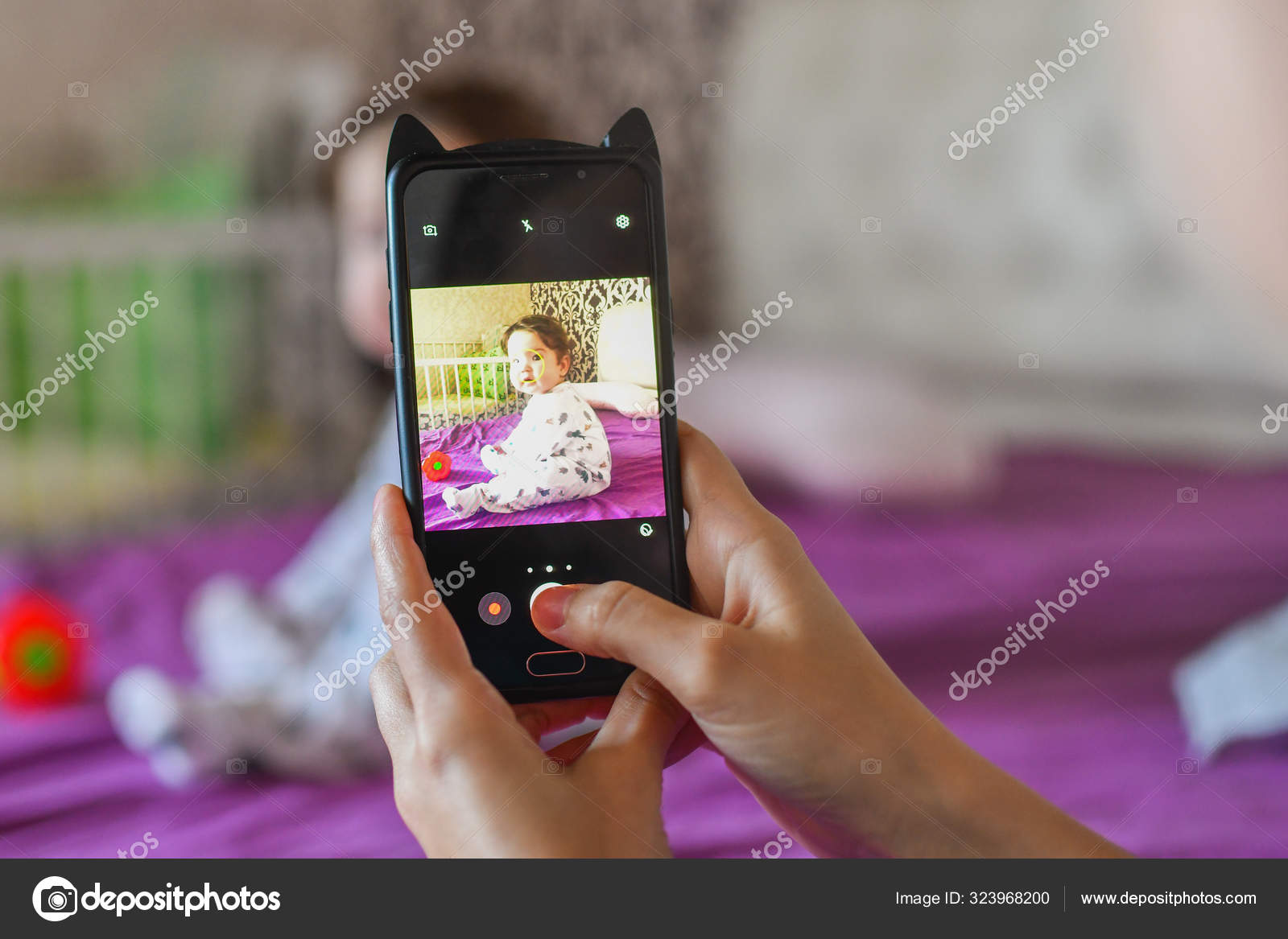 Mom photographs the baby on the close on the mom