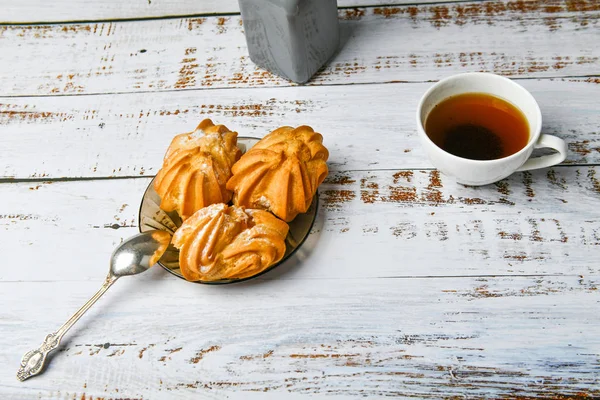 Café por la mañana con dulces. con relleno de crema. flat lay. sobre una mesa de madera clara. — Foto de Stock