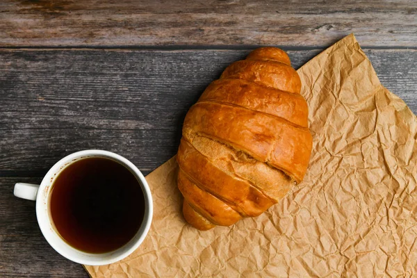Mañana con croissant. el comienzo de la mañana. Croissant francés fresco. Cafetería y croissants recién horneados en un entorno de madera. Vista desde arriba. Desayuno por la mañana con croissant y coff. — Foto de Stock