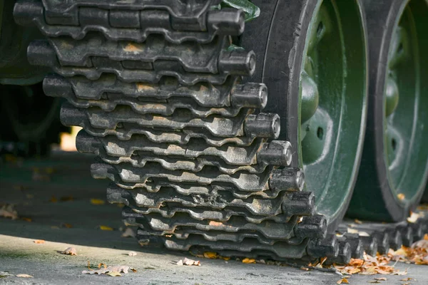 Tank caterpillars close-up. Iron caterpillars of the military heavy tank. Iron caterpillars and wheels of the military heavy tank.