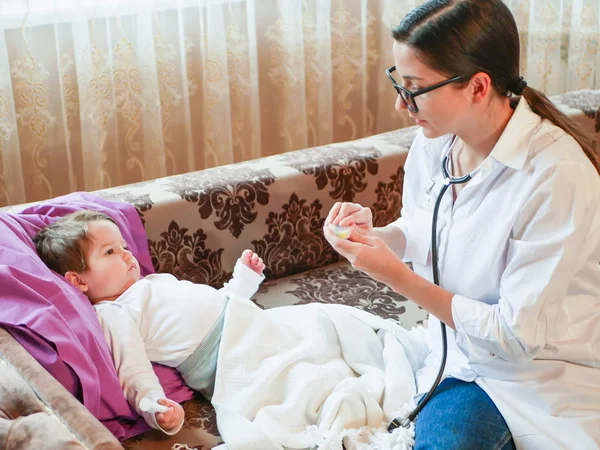 Childrens doctor gives pills to the child. First meeting with a doctor. the doctor is at home. call the address. Doctor on call.