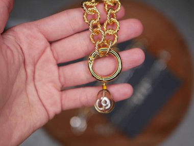 Elindeki altın zincir. Sevgililer Günü 'nde sevgilinden değerli bir hediye. Değerli mücevherler. Değerli metallerin alımı. Sevgili köpek kulübesi..