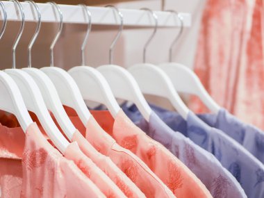 Kadın pijamaları mağaza askılarına asılır. Markette kadın pijaması satmak. Reklamcılık, satış, moda konsepti. Arka arkaya giyiniyor.