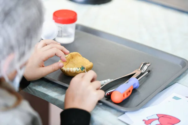 Masked children study medicine. Training class in dentistry. children and a dentist. Teaching Dentistry. Training at the dentist. KHARKOV, UKRAINE - JANUARY 20, 2020