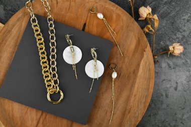 Ahşap bir arka planda altın mücevherler. Tüm aşıklar için mücevher. Ahşap arka planda zincirler. Yukarıdan görüntüle.