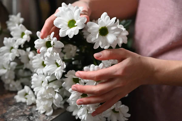 White flower in female hands. Healthy skin concept. Natural cosmetic. White flower in female ladies. health and beauty. The concept of hand care, anti-wrinkle, anti-aging cream, spa.