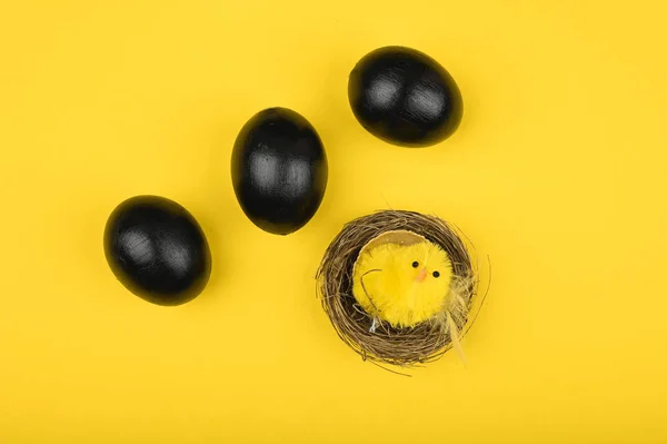 Pollo y huevos negros. Acostado. Pascua Negra. tres huevos negros — Foto de Stock