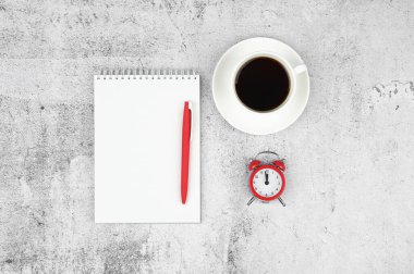 Time management concept. To-do list: red alarm clock, pencil and notebook.