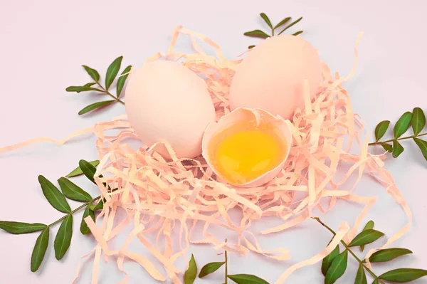 eco eggs on a white background. A tray of eggs on a white and pink background. eco tray with testicles. minimalistic trend, top view. Egg tray. Easter concept