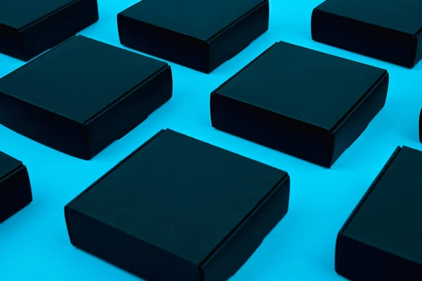 black cubes flow. black boxes on blue. black boxes on a blue background on a flat lay. Black square on blue