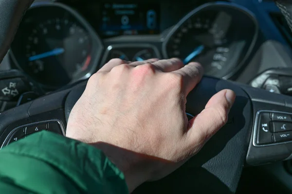 Hands hold the steering wheel of a car, bacteria on the steering wheel of a car.