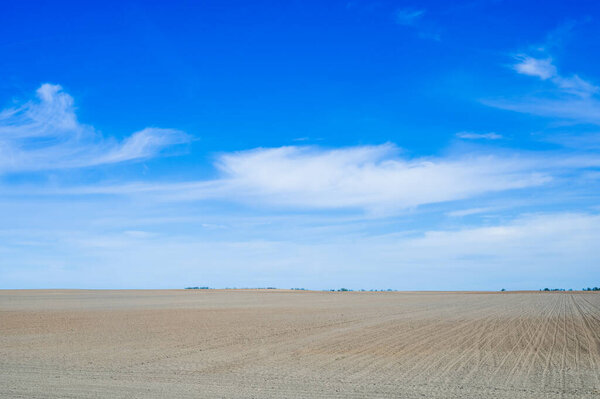Plowed field against the blue sky.