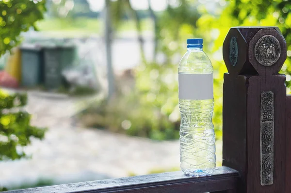 Empty plastic drinking water bottle in blurred trash bin backgrounds