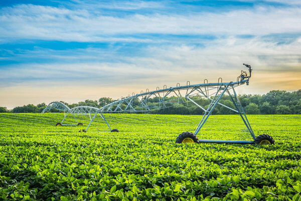 Irrigation System at Sunset with Cloudy Skies.