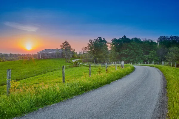 Sonnenaufgang entlang einer Landstraße mit Scheune — Stockfoto