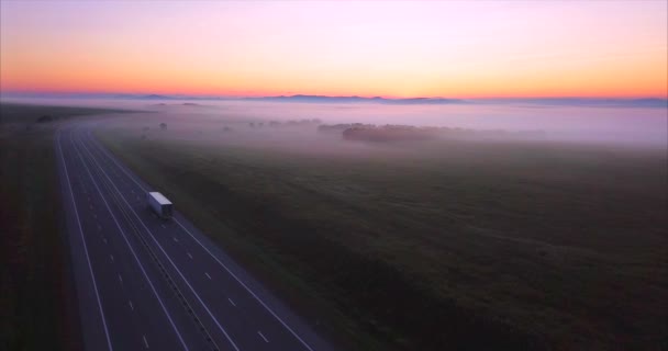 Aerial view of road with driving car, morning fields covered with fog. Russia — Stock Video