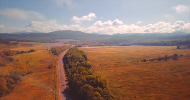 Ascending aerial view of highway with cars, fields and hills on horizon. Russia — Wideo stockowe