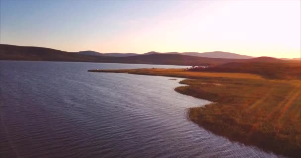 Flying above lake Blagodatnoye surrounded with green forests and hills. Russia — Stock Video