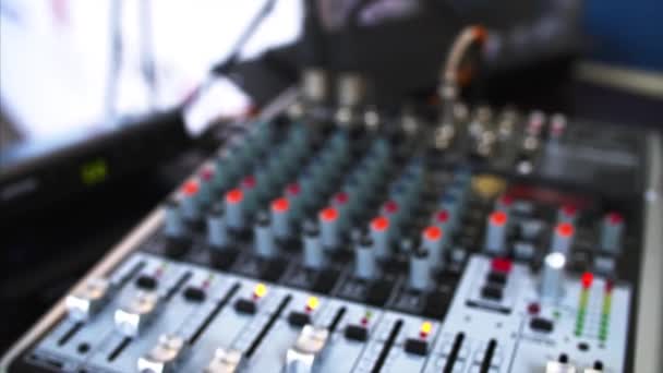 Close view of blurred sound console and closeup of two microphones — Stock Video